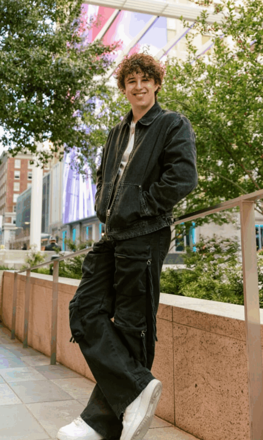 Owner of Chuck Vending leaning on brick wall, sharing the story behind our DFW claw machine rental company that brings fun, free-to-play claw machines to parties and events.