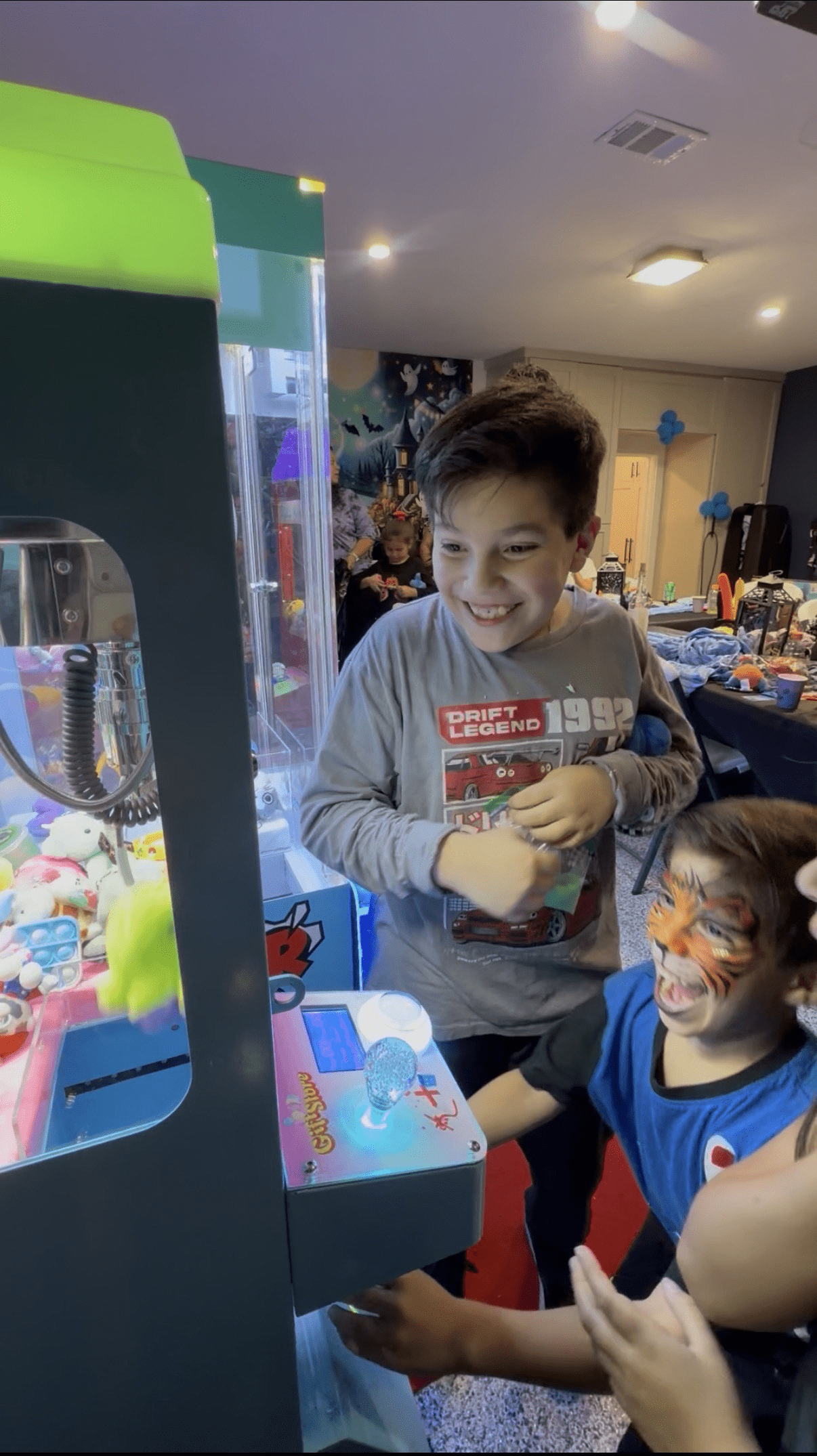 Kids enjoying a Chuck Vending claw machine