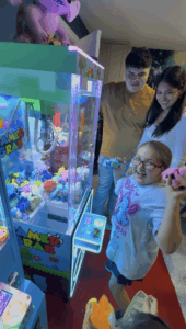 Excited girl winning prizes from a claw machine at her birthday party in Anna Texas