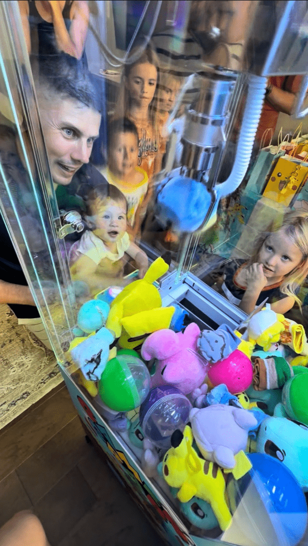 Child playing a Chuck Vending claw machine